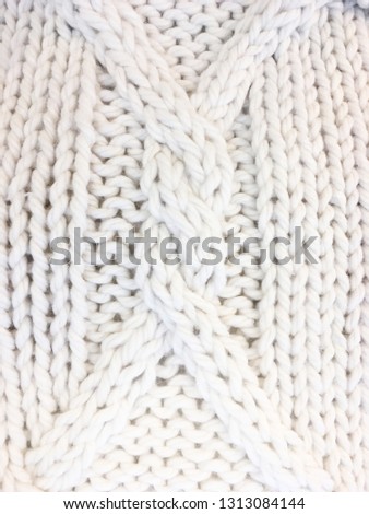 Background texture of pattern knitted fabric made of cotton or wool closeup
