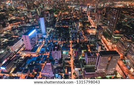 Cityscape of colorful crowded building with light traffic at Bangkok city at dusk