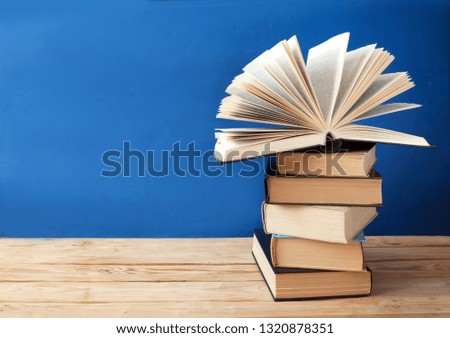 books pile on blackboard background, teacher's day concept