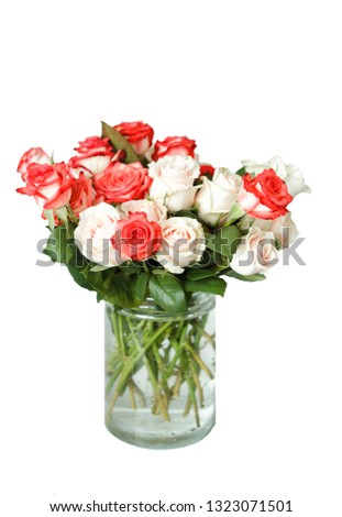 a bouquet of multi-colored roses  in a glass vase isolated white background