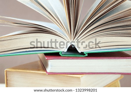 books pile with open book closeup