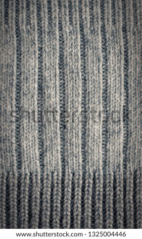 Knitted texture. Texture of knitted woolen fabric for Wallpaper and an abstract background. Knitted elastic.