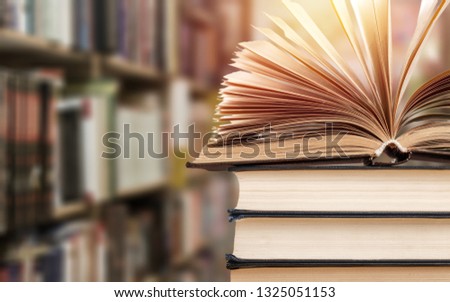 Old stacked books on blurred background