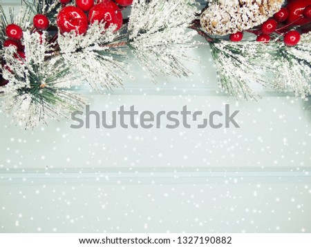 christmas background fir tree branch with cones and snow on wooden blue board