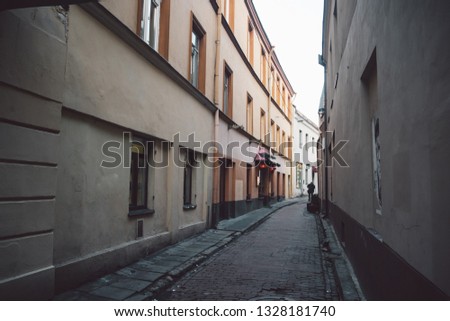 Ancient narrow Vilnius street with old architecture and winter background