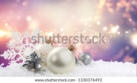 Silver christmas balls over snow isolated on white