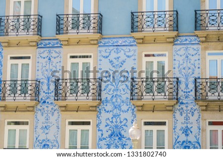typical portugies facade with blue tiles and balconies in porto, portugal