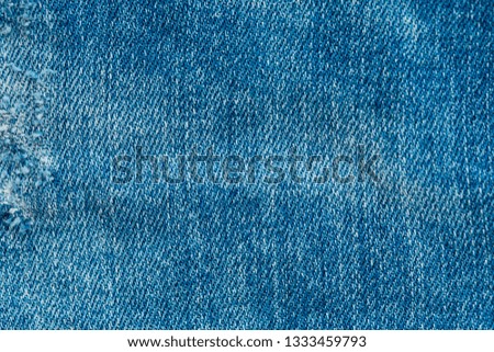 Blue denim jeans background. Denim jeans fabric texture or denim jeans background with old torn. Old grunge vintage denim jeans.