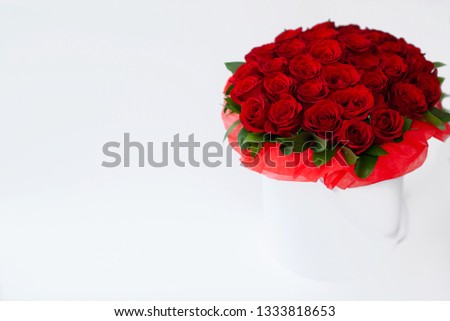 bouquet of red roses in a white box on a white background