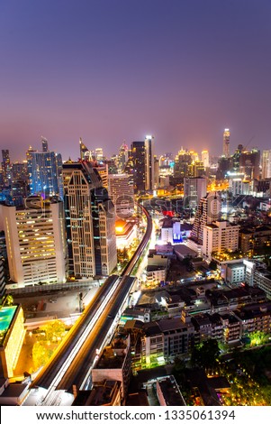 High angle view of Bangkok, Thailand. Various buildings open neon lights. Makes the image look beautiful With contrasting white light with orange and purple sky