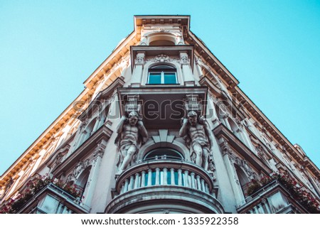 Facade detail of two men carrying the building in Zagreb, Croatia