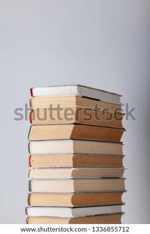 
Stack of vintage books on a gray background.