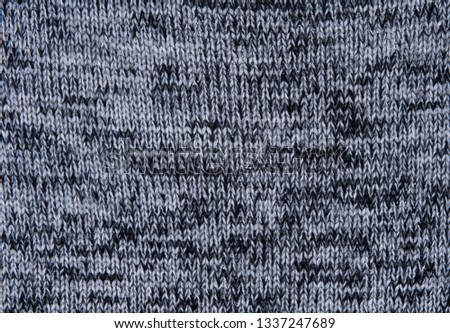 Gray texture background of faded grey colored sweater.
