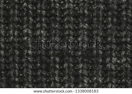 Real black knit texture. Background, pattern concept. Knitted fabric made of heathered yarn