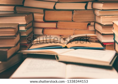 Open book on wood desk in the library room with blurred focus for education background and back to school concept