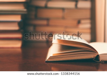 open book on the table against the background of books