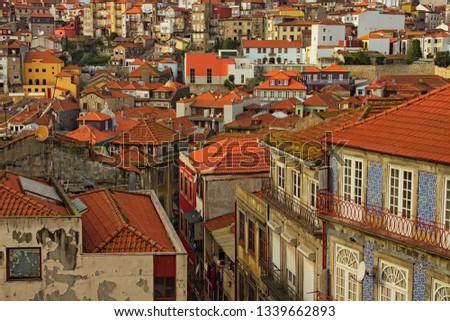 Stunning aerial view of traditional historic buildings in Porto. Vintage houses with red tile roofs. Famous touristic place and travel destination in Porto, Portugal.