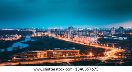 Minsk, Belarus. Panoramic Aerial View Cityscape In Bright Blue Hour Evening And Yellow Illumination Spring Twilight.