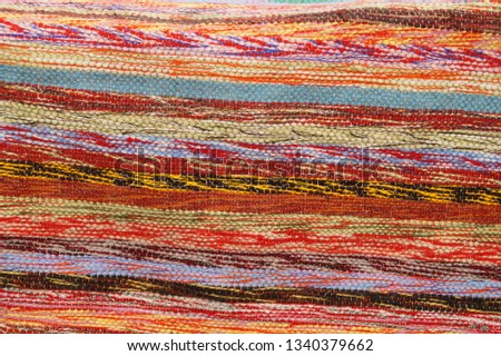 Handmade carpets set made from old used clothes. Reuse and upcycling concept, zero waste, ecology. Homespun multicolored rugs. Close-up of patchwork or braided rug, weaving texture