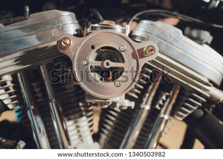 Motorcycle engine, metallic background with exhaust pipes.