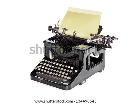 Old black typewriter, keyboard and writing paper