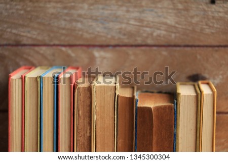 Close-up pictures of many old books, arranged in rows Old wooden floor as background selective focus and shallow depth of field