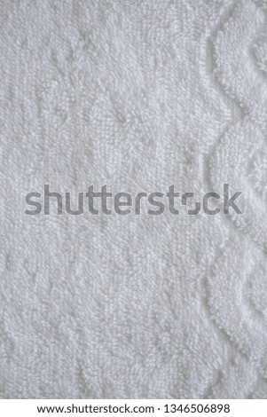 White delicate soft background of fur plush smooth fabric. Clean white towel blanket textile vertical photo. Copy space