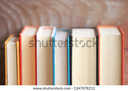 Close-up of books arranged old wooden floor as background selective focus and shallow depth of field