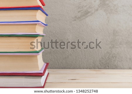 Education and reading concept - group of colorful books on the wooden table