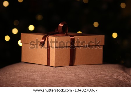 close-up open and closed gift box with brown ribbon