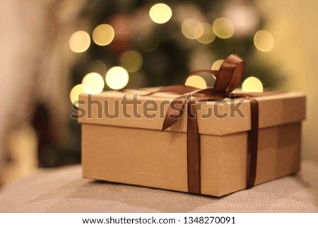 close-up open and closed gift box with brown ribbon