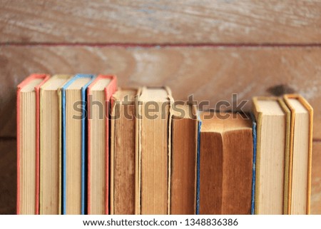 Close-up pictures of many old books, arranged in rows Old wooden floor as background selective focus and shallow depth of field