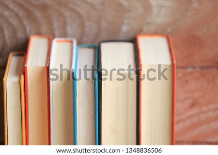 Close-up of books arranged old wooden floor as background selective focus and shallow depth of field