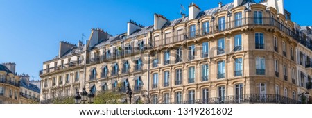 Paris, beautiful building in the Marais, typical parisian facade and windows
