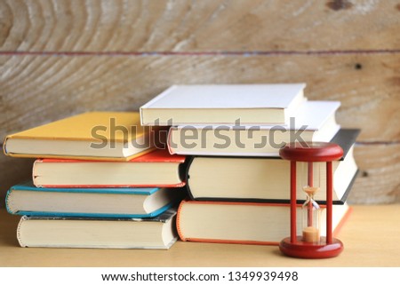 Close-up of many books overlapping Old wooden floor as background selective focus and shallow depth of field