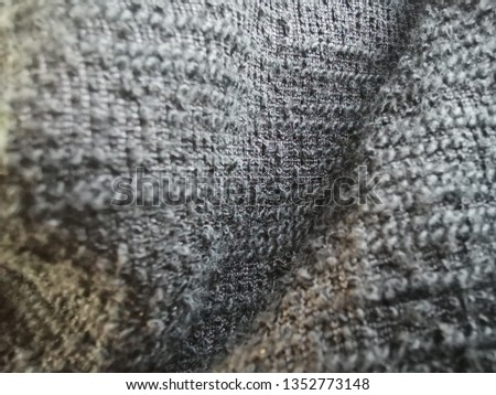 Blurred fabric fibers with blurred pattern background