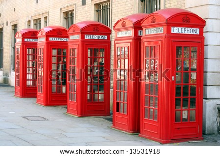 A photography of five old red phone boxes in London