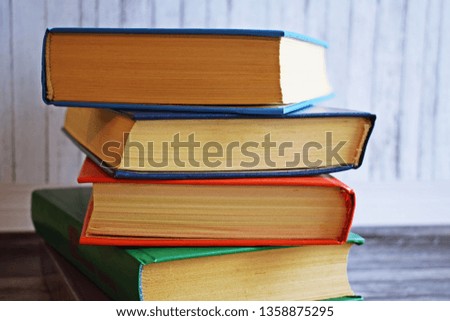Stack of books on a wooden background.Education.