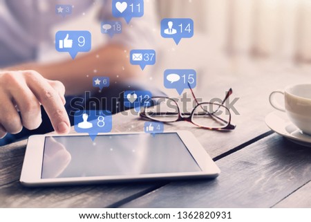 Social media network interactions concept with icons of comments, friend contact requests and messages showing engagement from users and digital marketing on mobile devices, person touching screen