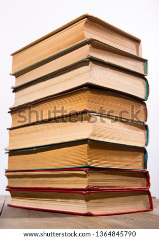A stack of vintage books on white background.