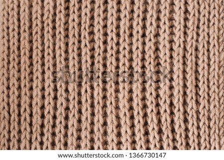 Knitted background. Knitted texture. Knitting pattern of wool. Knitting. Texture of knitted woolen  fabric for wallpaper and an abstract background