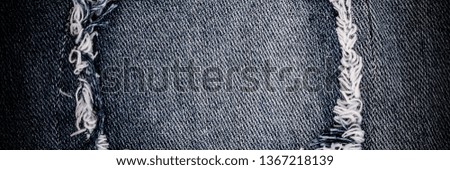 Destroyed torn ripped denim dark blue jeans patch. Ripped Destroyed Torn Denim Frame. Close up denim jean texture banner