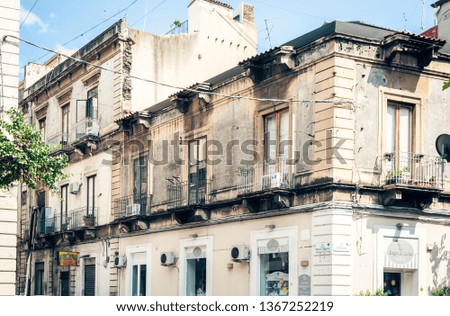 Traditional architecture of Sicily in Italy, historical street of Catania, facade of old buildings