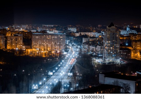 Night road with houses. Street with LED lights. Illumination of the avenue with white light.