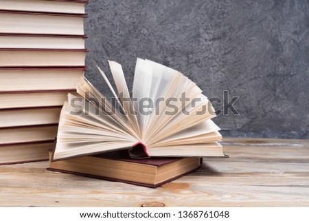 open book, books on the gray concrete background. Back to school. Education. Copy space for text
