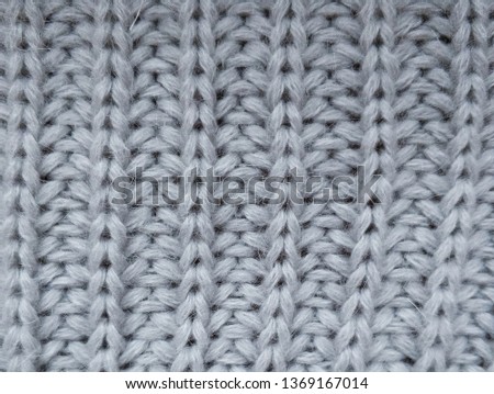 The texture of knitted gray fabric. Warm Material sweaters.