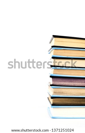 Stack of black and blue books isolated on white