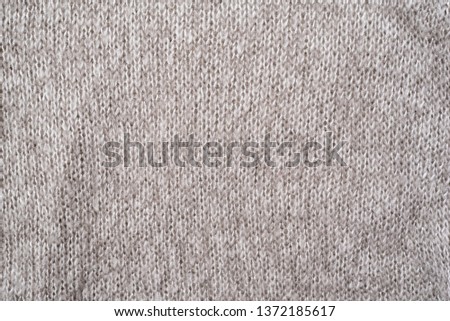 Texture of a gray wool knitted sweater. Close-up. Seamless