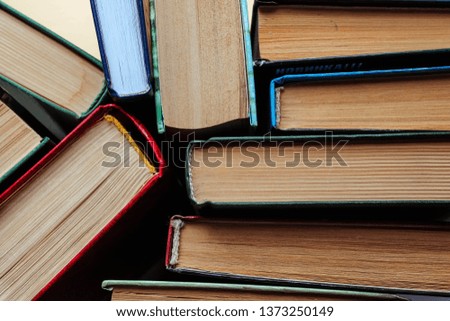 Old used shabby books with a cardboard cover, top view. Educational concept.