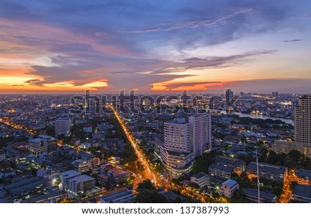 Traffic in Bangkok with bursting sky at twilight